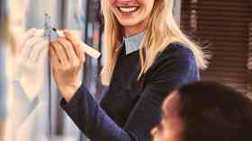 Teacher writing on whiteboard