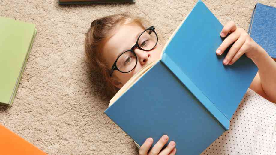 Young boy reading book
