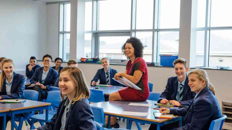 Smiling teacher in high school lesson