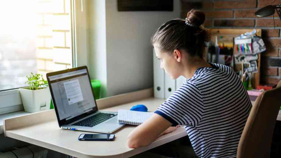 Girl studies on laptop.