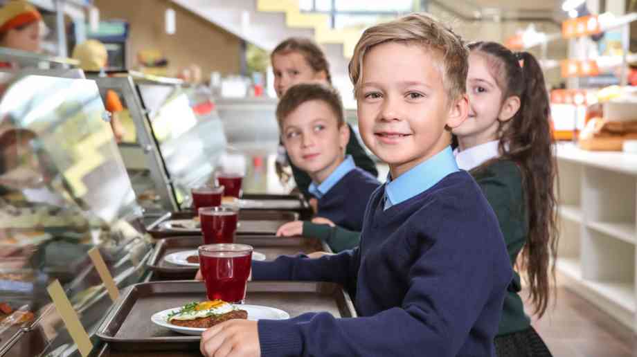 School children queue for lunch.