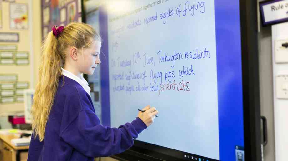 A Year 5 student using a Promethean ActivPanel at Torkington Primary School