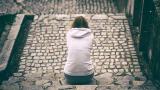 Teenager sitting alone