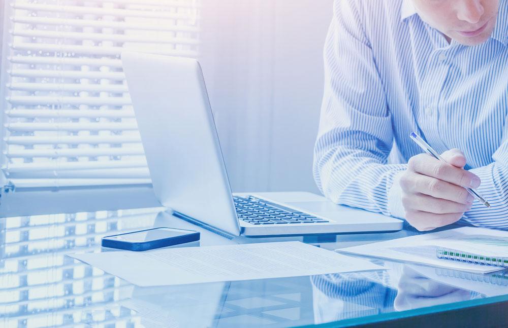 Man with a laptop and calculator